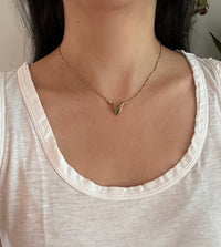 Two Hands Holding an Emerald Necklace in 18K Gold with Diamond Cuffs (I)